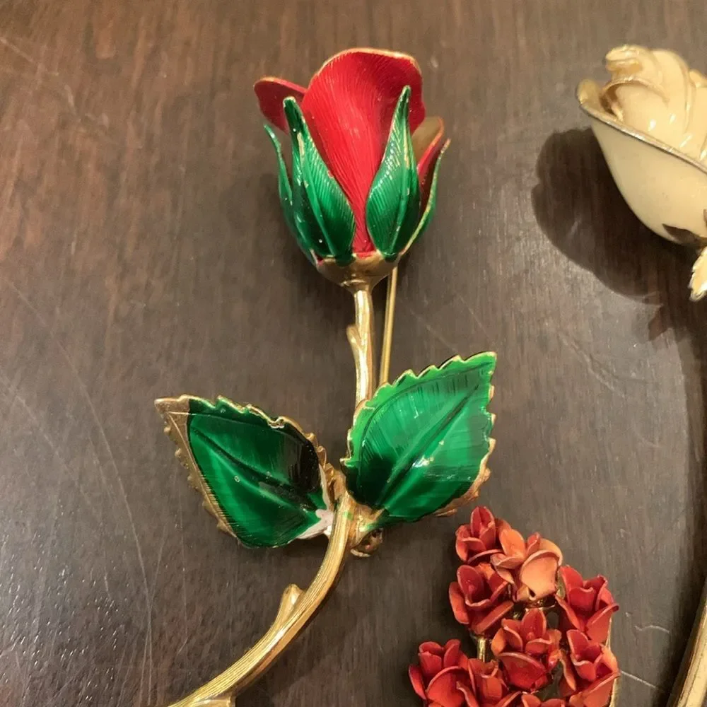 Three vintage rose brooches